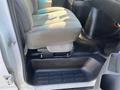 Interior view of a 2016 GMC Savana showing the driver's seat and flooring area with a textured mat and space for the feet