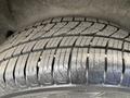 A close-up of a tire from a 2013 Ford Transit Connect showing tread patterns and worn areas