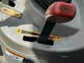 Close-up of a control panel on a 2011 Kubota M8540D tractor featuring levers and safety warning labels