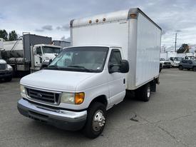 A white 2005 Ford Econoline cargo van with a box truck body and dual rear wheels standing in a lot