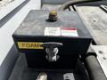 A black foam tank fill box with a yellow label and a lever on the front