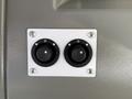 Two black circular switches mounted on a white plate, each with a central dial and three indicator dots arranged around the perimeter