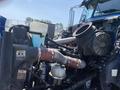 Close-up view of the engine components of a 2008 Peterbilt 340 including various hoses tanks and a silver canister