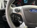 Close-up of a steering wheel from a 2017 Ford Transit Connect featuring control buttons and the Ford logo