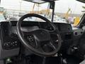 The interior of a 2020 International MV607 truck featuring a steering wheel dashboard controls and instrument panel
