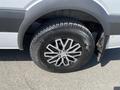 A 2010 Mercedes-Benz Sprinter with a silver exterior featuring an alloy wheel and a rugged tire mounted on its front axle