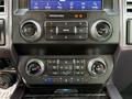 Dashboard controls of a 2021 Ford F-350 SD featuring audio controls climate settings and temperature dials