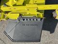 A close-up view of a yellow attachment on a Kubota F3990 featuring a black cover marked with the text DO NOT REMOVE