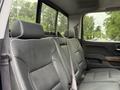 The interior of a 2017 Chevrolet Silverado 1500 showing the rear leather seating with seat belts and headrests