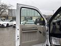 A white 2008 Ford F-250 SD with the driver's door open showing the interior door panel and controls