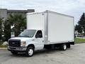 A white 2019 Ford Econoline box truck with a large cargo area and black grille parked on a concrete surface