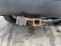 A rusty trailer hitch attached to a 2015 Dodge Durango