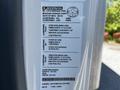 A 2020 Hino 155 truck door with a manufacturing label detailing specifications including weight capacity and tire information