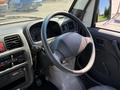 Interior view of a 2009 Suzuki Carry showing the steering wheel dashboard and control panel
