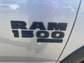 A close-up view of the RAM 1500 Classic badge mounted on a silver truck's side door displaying the RAM logo and the number 1500