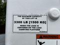 Label on a Hino 338 truck indicating the maximum lift capacity of 3300 lb 1500 kg when the load is centered on the carrying platform