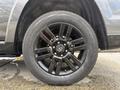 A black alloy wheel with several spokes featuring a Toyota logo at the center mounted on a Yokohama tire