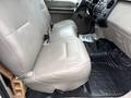 The interior of a 2008 Ford F-250 SD shows a gray leather bench seat with seat belts and a rubber floor mat beneath