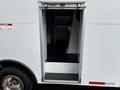 A 2017 Ford Econoline with an open side door revealing a step and interior space