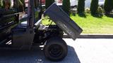 A 2016 Polaris Ranger 570 Crew with the cargo box raised exposing the engine compartment and showcasing a rugged black exterior