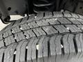 A close-up of a tire from a 2016 Ford Econoline showing detailed tread patterns and small debris embedded in the grooves