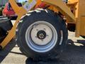 Close-up of a black tire mounted on a metal rim belonging to a yellow Traner TR 45 machine showcasing rugged tread design