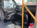 Interior of a 2018 Chevrolet Express showing driver's seat dashboard controls and a yellow handrail