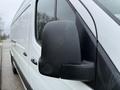 A close-up of the side mirror on a 2019 Mercedes-Benz Sprinter van