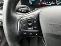 Close-up of a steering wheel with control buttons for setting and adjusting cruise control features in a 2021 Ford Transit