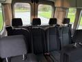 Interior of a 2019 Ford Transit van featuring black fabric seats arranged in two rows with headrests and seatbelts