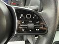 Close-up of the steering wheel control panel of a 2019 Mercedes-Benz Sprinter featuring buttons for volume navigation and various functions