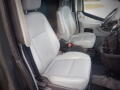 Interior view of a 2015 Ford Transit showing two light gray front seats with adjustable headrests and a steering wheel visible