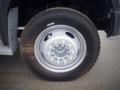 A close-up view of a 2008 Ford F-550 wheel featuring a silver rim with multiple lug nut holes and a black tire with a rugged tread pattern