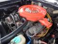 An orange air cleaner labeled 360 sits atop a vintage engine with various hoses and wires visible in a classic 1974 Dodge Challenger