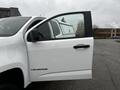 White 2018 Chevrolet Colorado pickup truck with an open driver's side door showcasing the interior details and window view