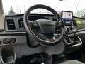 Interior view of a 2020 Ford Transit showcasing the steering wheel dashboard and a touchscreen display