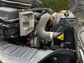 Close-up of the engine compartment of a 2012 International DuraStar 4300 displaying the air intake hose and various engine components