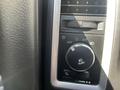 A control panel for lighting in a 2011 RAM 1500 featuring a knob for headlight adjustment with labeled settings and a button for fog lights