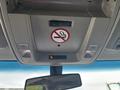 The overhead console of a 2016 GMC Sierra 1500 featuring controls for lights and a no smoking sign