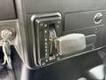 Close-up of the gear shift panel of a 2022 International MV607 displaying gear settings R N D 4 2 1 with a textured lever and adjacent ignition key slot