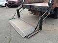 A 2008 Mitsubishi Fuso FE180 with a lowered hydraulic liftgate extending from the rear for loading and unloading cargo