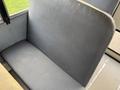 A gray bench seat from a 2013 International 4300 with a smooth texture and no visible upholstery details