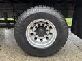 A close-up view of a heavy-duty tire on a 2017 Freightliner M2 106 with a silver wheel and rugged tread pattern