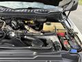 A 2017 Ford F-350 SD engine bay showing various components including hoses a coolant reservoir and a battery