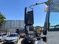 A 2018 International DuraStar truck mirror showing two reflective surfaces with a chrome finish and a black housing design