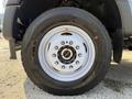 A close-up view of the wheel of a 2022 Ford F600 showcasing the tire and rim details