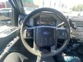 Interior view of a 2016 Ford F-350 SD with a steering wheel and dashboard featuring gauges and controls