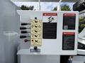 A 2020 Freightliner M2 with control panels featuring various switches and safety warnings related to electrical and operational hazards