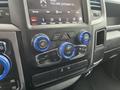 Interior control panel of a 2019 RAM 1500 Classic featuring climate and audio buttons with blue accents