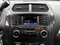 The dashboard of a 2019 Ford Explorer featuring a radio display climate controls and various buttons and knobs